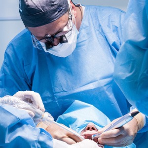 Dentists performing a dental implant surgery
