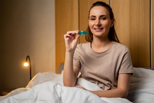 Patient in Black Forest holding oral appliance