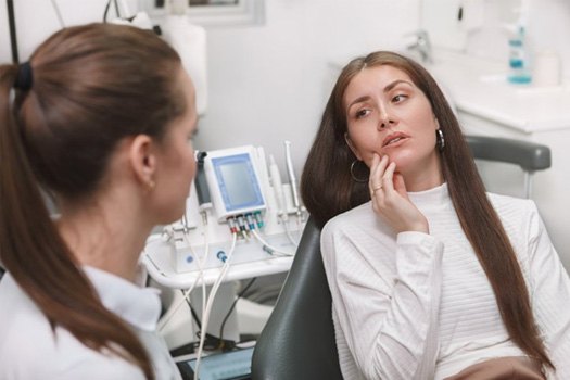 Patient in Black Forest holding cheek due to dental pain